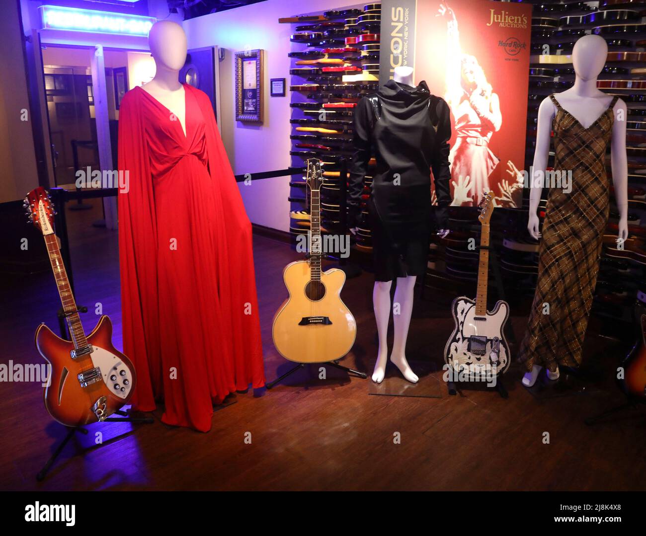 New York, New York, USA. 16th May, 2022. A view of (L-R) 1984 12-String Rickenbacker 360/F12-FG-WB-B electric guitar signed and inscribed by Tom Petty, custom red gown by Kesha to the 2018 Grammy Awards Sony Music after party, Takamine acoustic/electric guitar played by Bruce Springsteen during the Born in the U.S.A. tour, black tunic with a Demobaza label worn by Janet Jackson during the Glastonbury Festival in 2019, Waylon Jenning's custom Fender Telecaster and Bob Mackie gown worn by Cher during the TV show ''˜The Sonny and Cher Comedy Hour' seen on display at the press preview for Juli Stock Photo