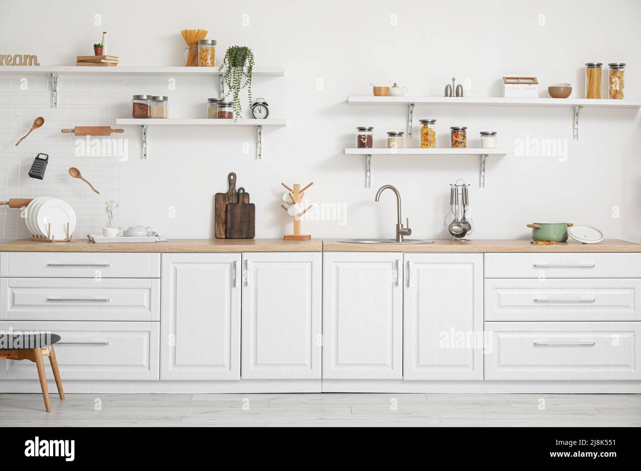 Interior of light kitchen with white counters and utensils Stock Photo ...