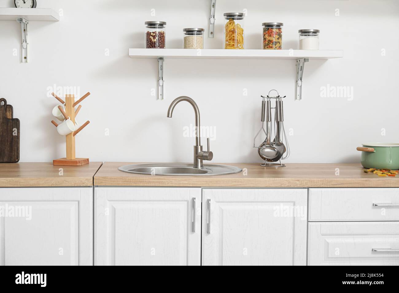 Interior of light kitchen with white counters and utensils Stock Photo ...