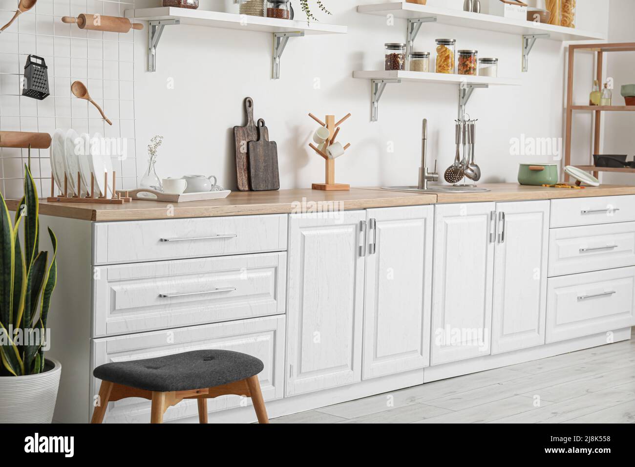 Interior of light kitchen with white counters and utensils Stock Photo ...