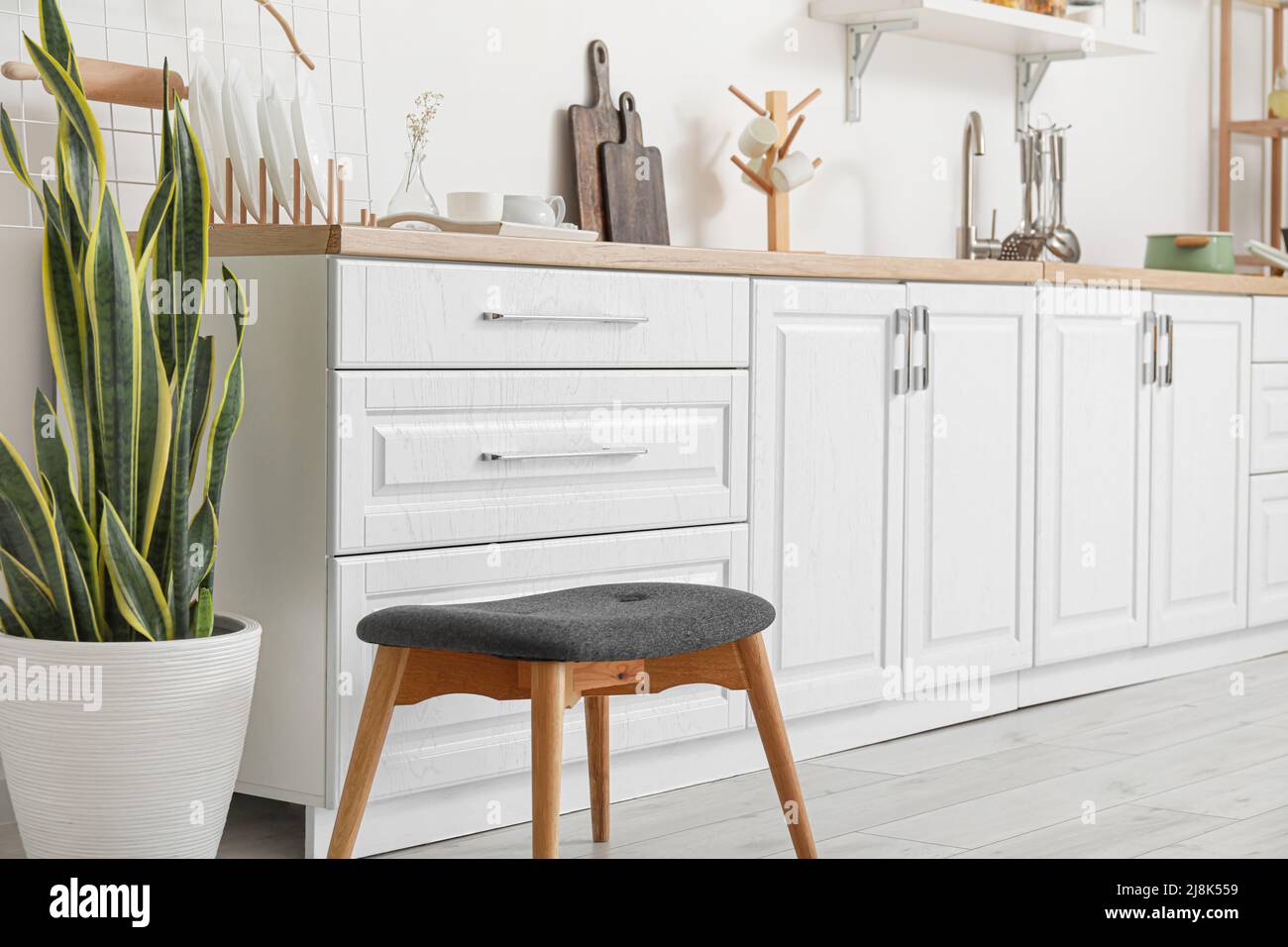 Interior of light kitchen with white counters and utensils Stock Photo ...