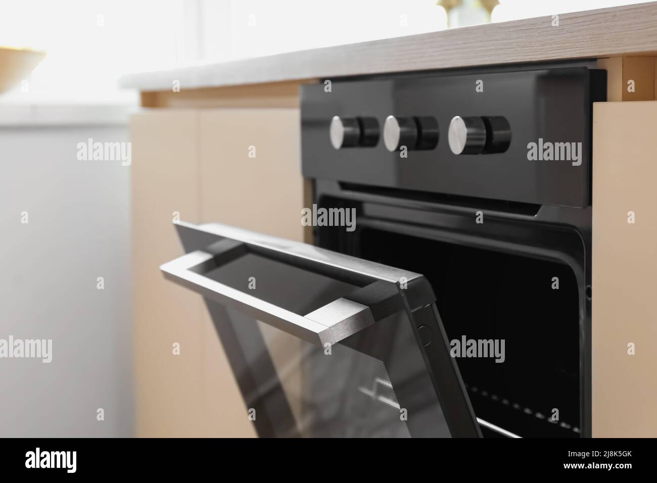 Modern electric oven with knobs in kitchen, closeup Stock Photo Alamy
