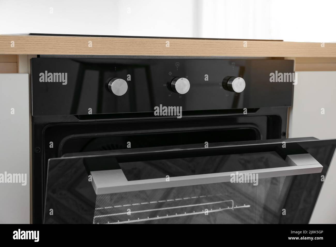 Modern electric oven with knobs in kitchen, closeup Stock Photo Alamy
