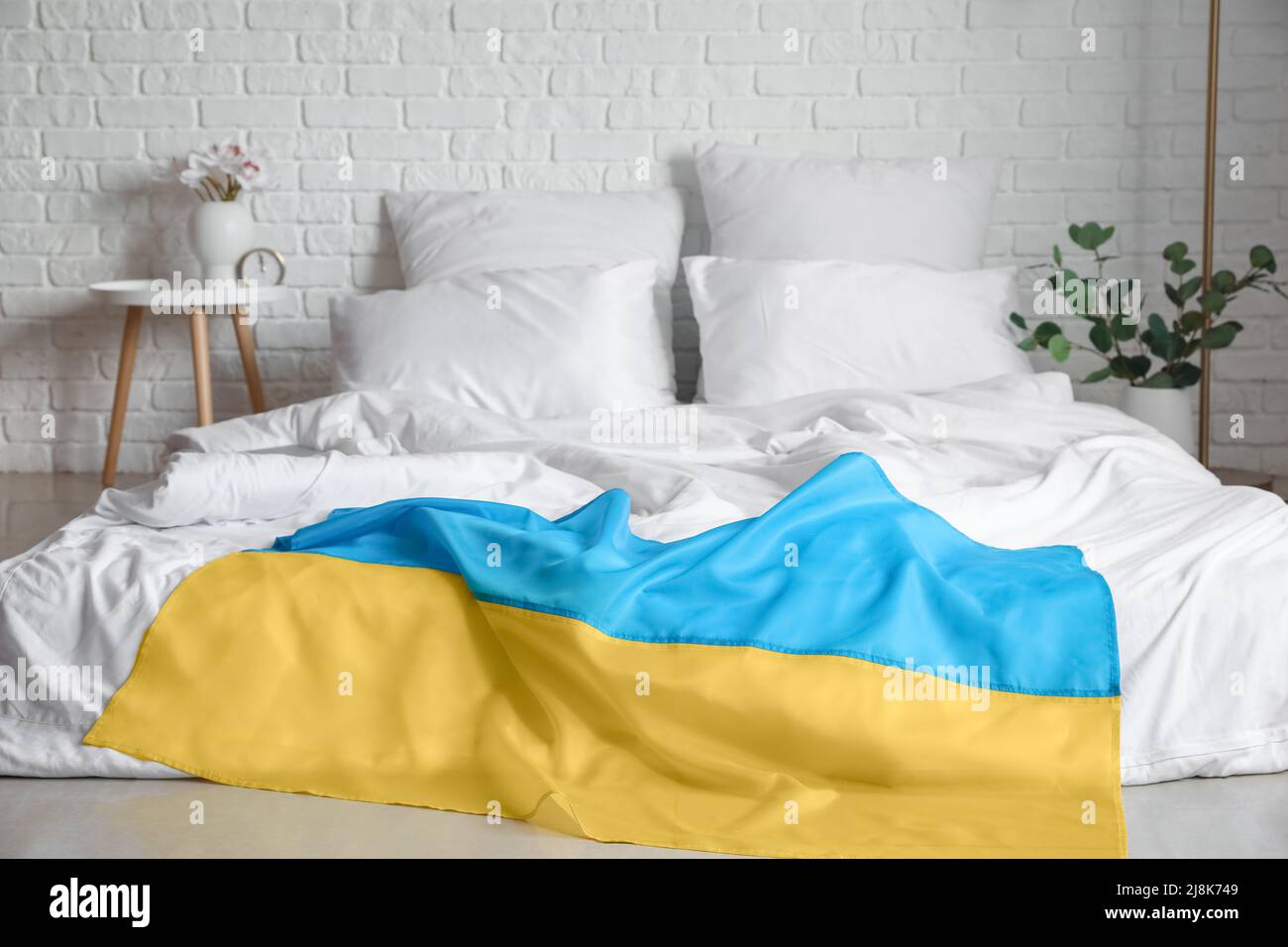 Flag of Ukraine on comfortable bed in light room Stock Photo - Alamy