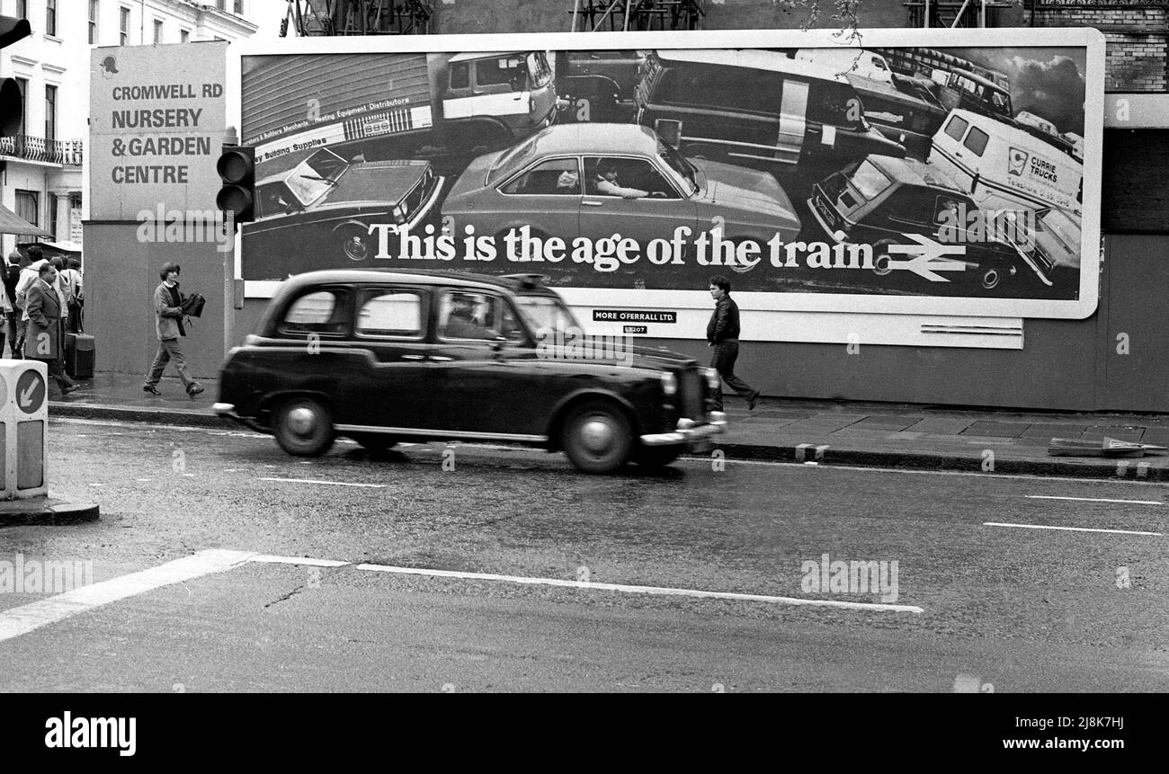 Billboard promoting train travel in street scene, 1981, London, England Stock Photo