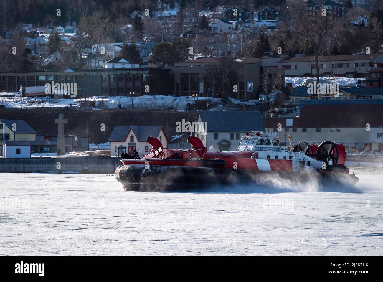 Coast Guard hovercraft breaking ice near a small community in eastern Quebec, Canada.  Stock Photo