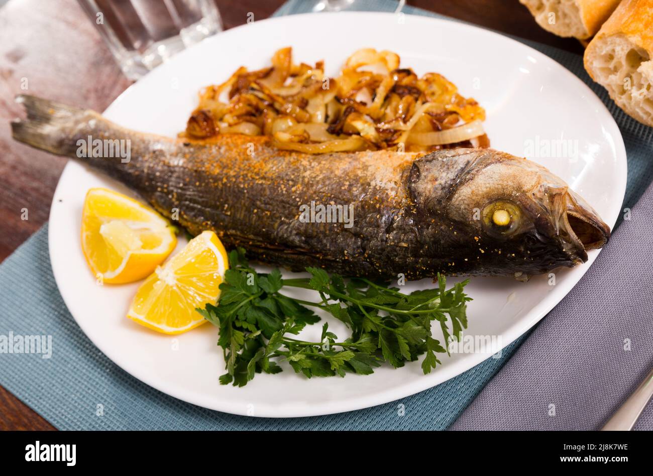 Oven baked sea bass fish Stock Photo Alamy