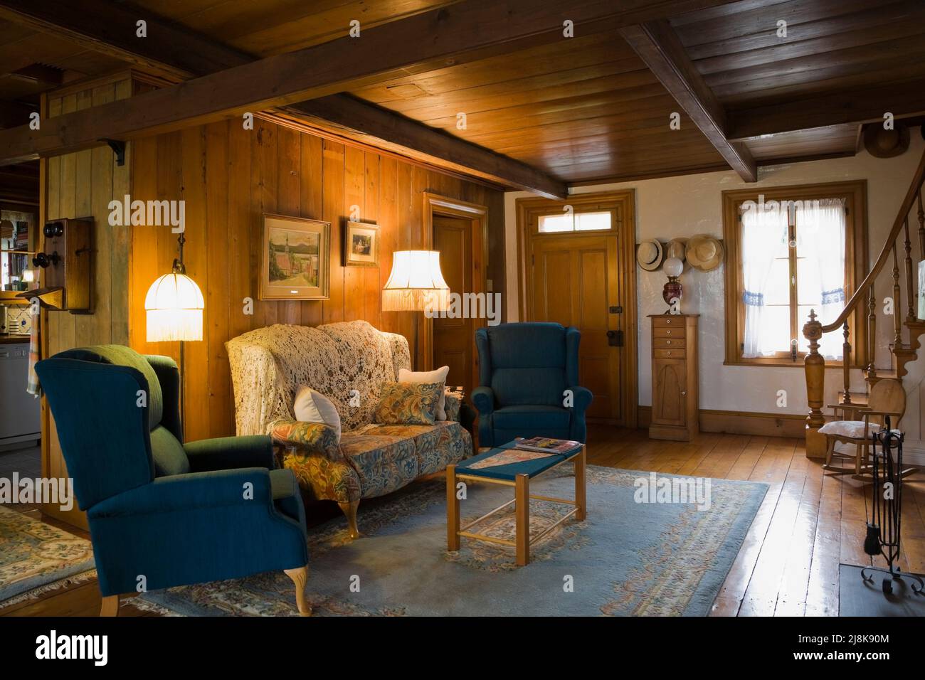 Antique blue upholstered armchairs and sofa in living room inside old