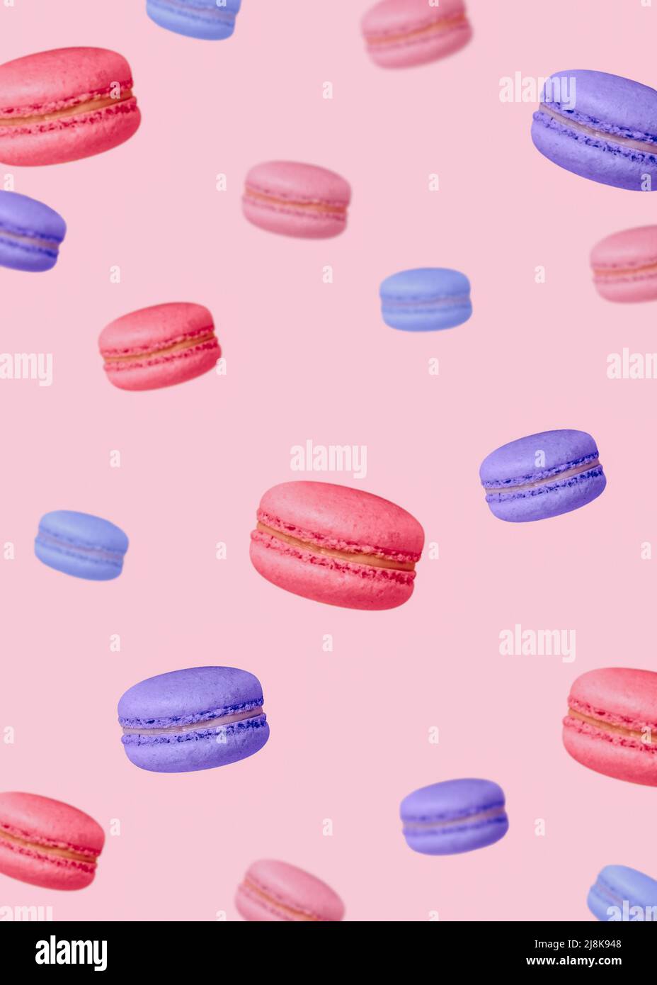 Colorful french biscuits on pastel pink backdrop Stock Photo