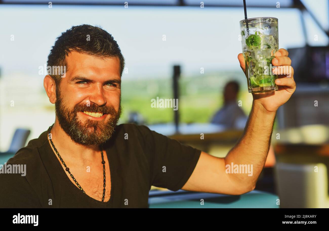 Happy man in classical suit holding glass with beer in hand. Smiling ...