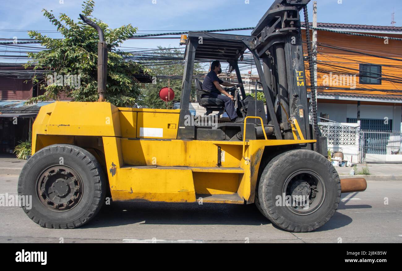 SAMUT PRAKAN, THAILAND, APR 06 2022, A big forklift is driving on the street in the city Stock Photo