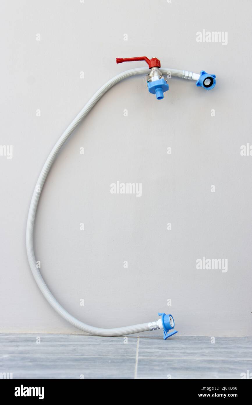Outdoor water tap with washing machine hose ready for connection Stock