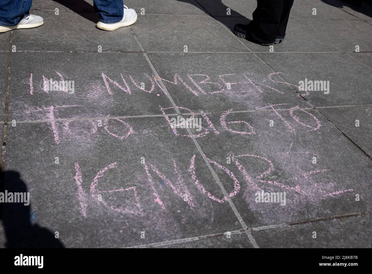 NEW YORK, N.Y. – March 7, 2021: People stand near a chalked message at a Manhattan rally in support of the Equal Rights Amendment. Stock Photo