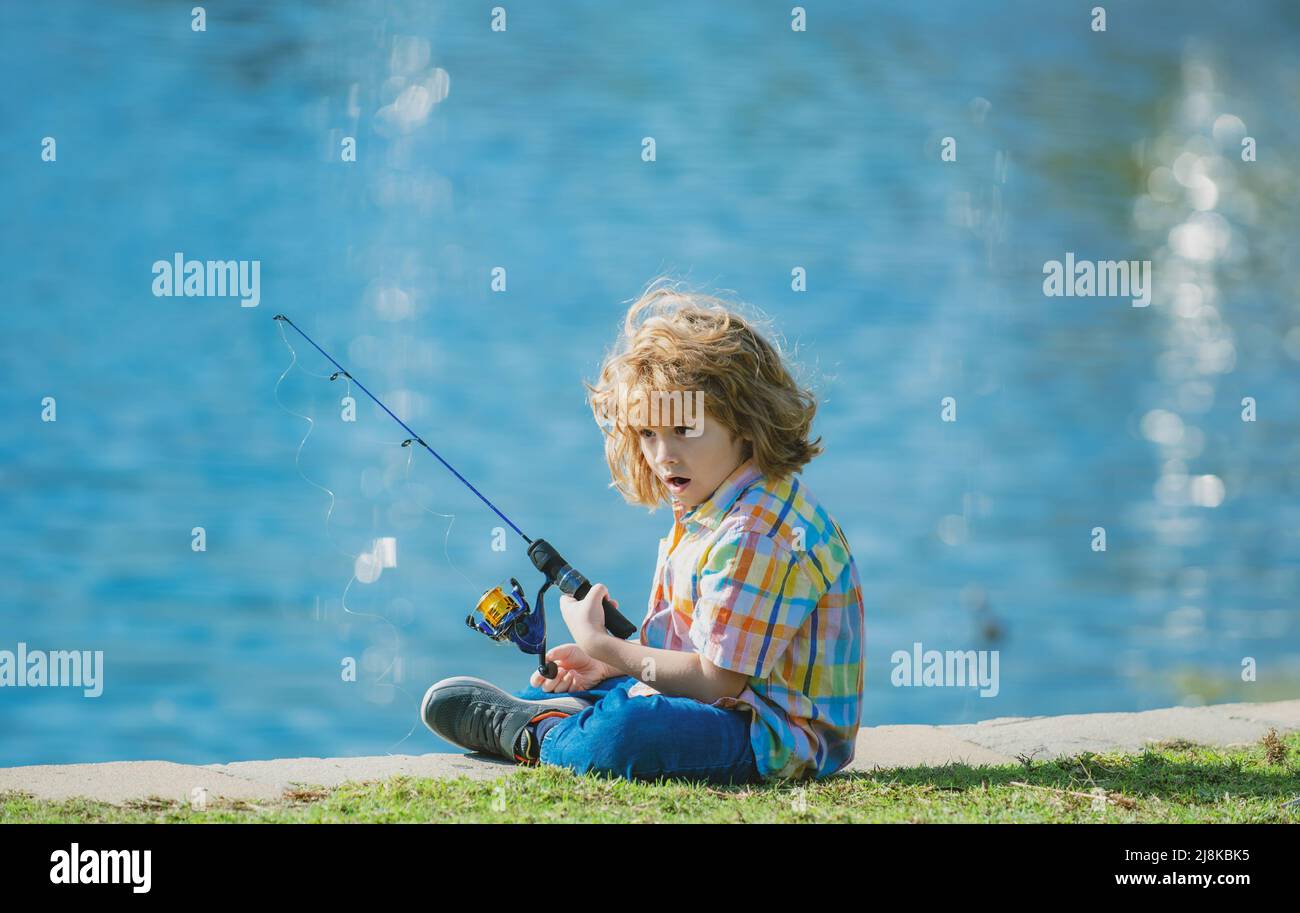 Happy child fishing on the lake. Boy with spinner at river. Fishing