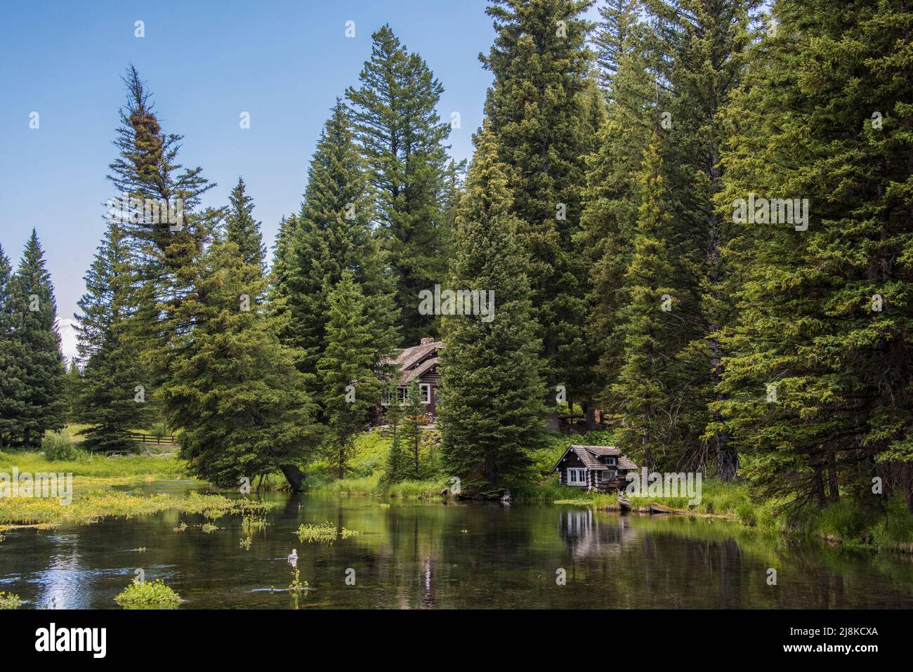 Historic Johnny Sack's Cabin at Big Springs is at the headwaters of the Henry's Fork of the Snake River. Island Park, Fremont County, Idaho, USA Stock Photo