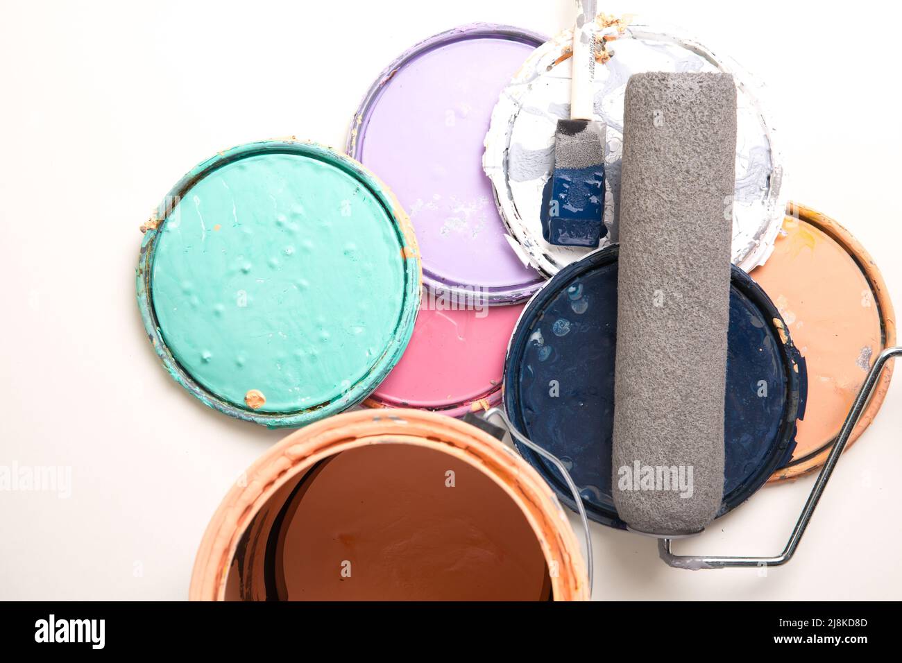 Assorted Paint Can Lids Paint Can paint roller and brush on a white