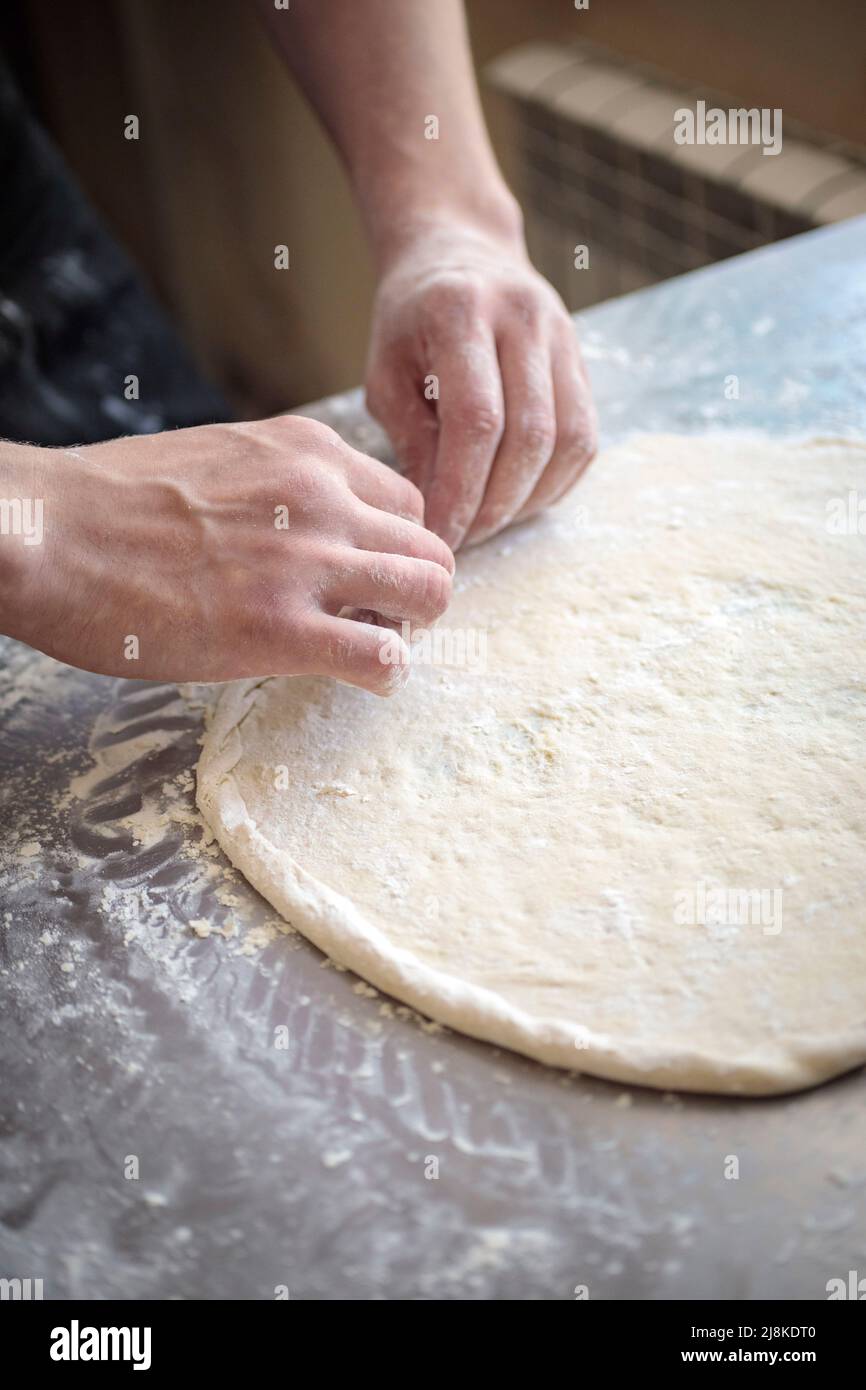 hands of the cook kneading pizza dough close-up Stock Photo - Alamy
