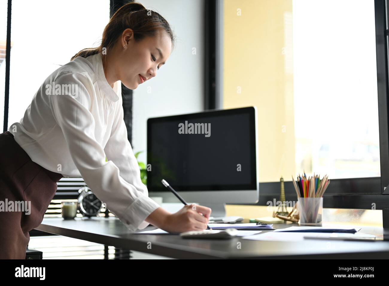 Asian businesswoman leaning on desk hi-res stock photography and images ...