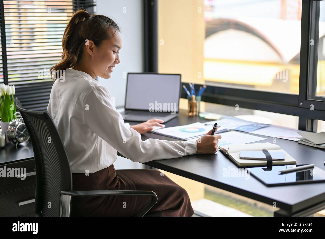 Manager Asian Report Asian female manager reviewing a business financial annual report in ...