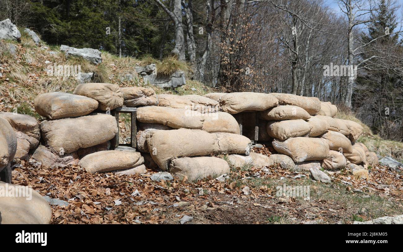 sandbags to protect a war trench dug inside the mountain to defend against enemy attacks Stock Photo