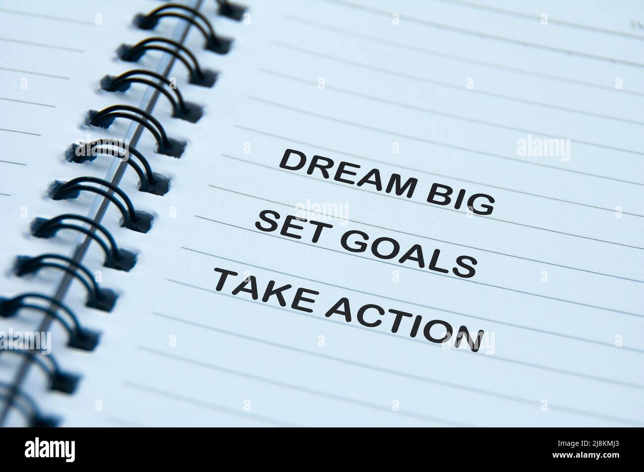 Motivational and inspirational quotes text on notepad - Dream Big, Set Goals, Take Action Stock Photo
