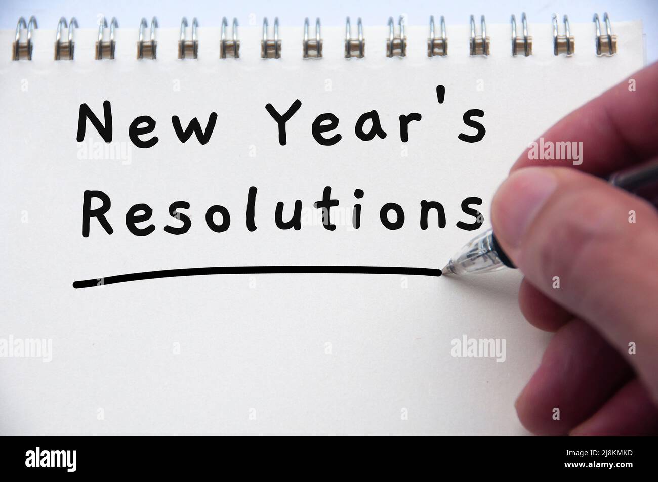 Hand writing new year resolution text on notepad. New year's resolution