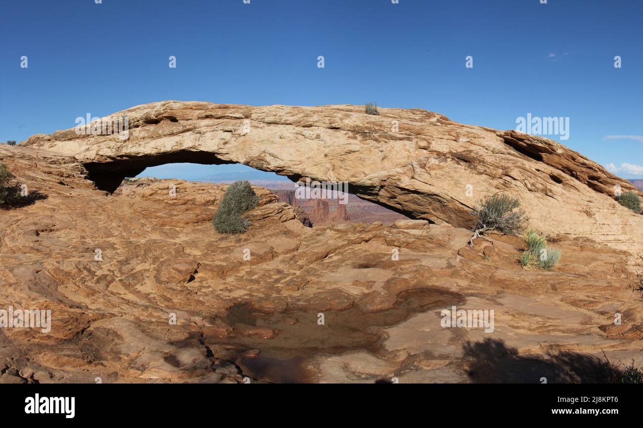 Mesa Arch in Canyonlands Utah America. Also known as Rotary Arch or Trail Arch. Natural stone Arch in front of Blue Sky. High Resolution for Poster. Stock Photo