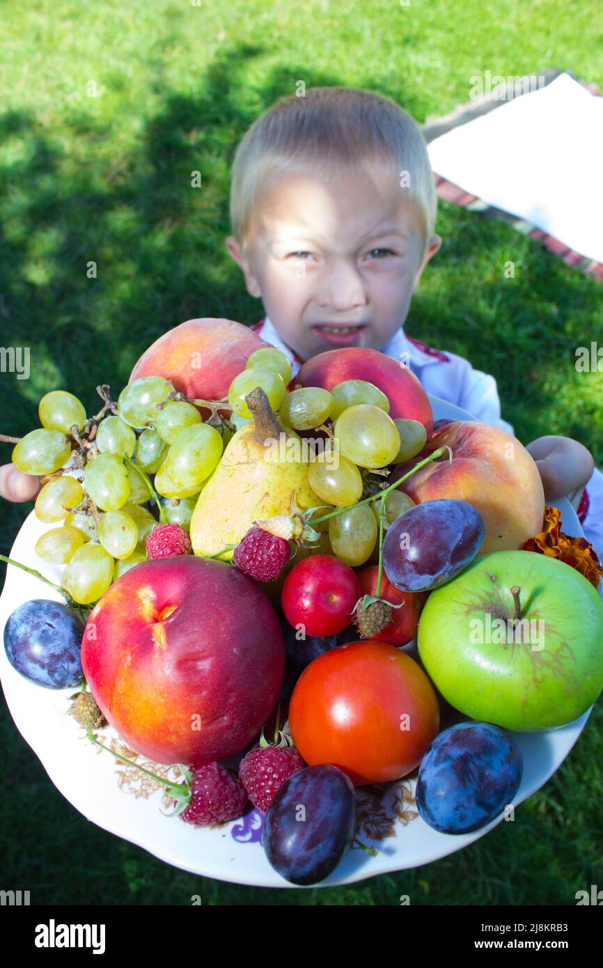 boy holds fruit Stock Photo