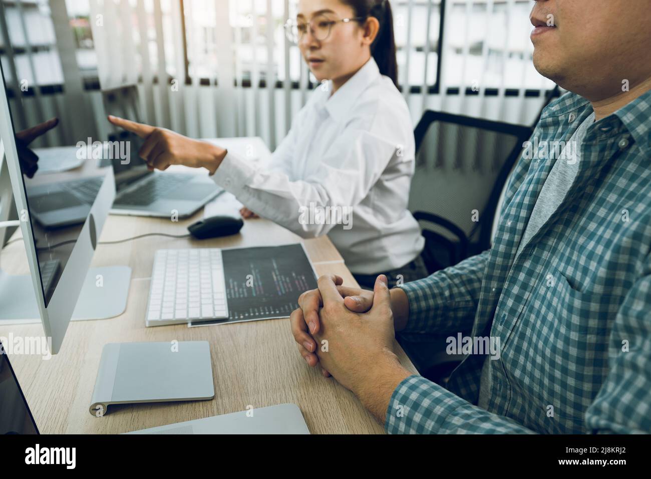 Two asian team working development of programming and encryption technology website design programmers on desk in office. Stock Photo