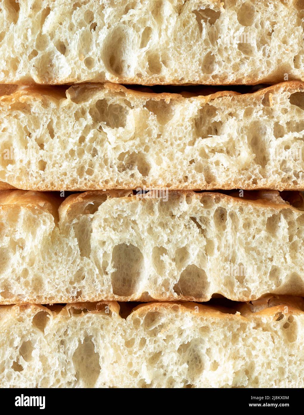Close-up with slices of focaccia bread made with sourdough. Full-frame background with slices of focaccia in a pile. Homemade focaccia with sourdough Stock Photo