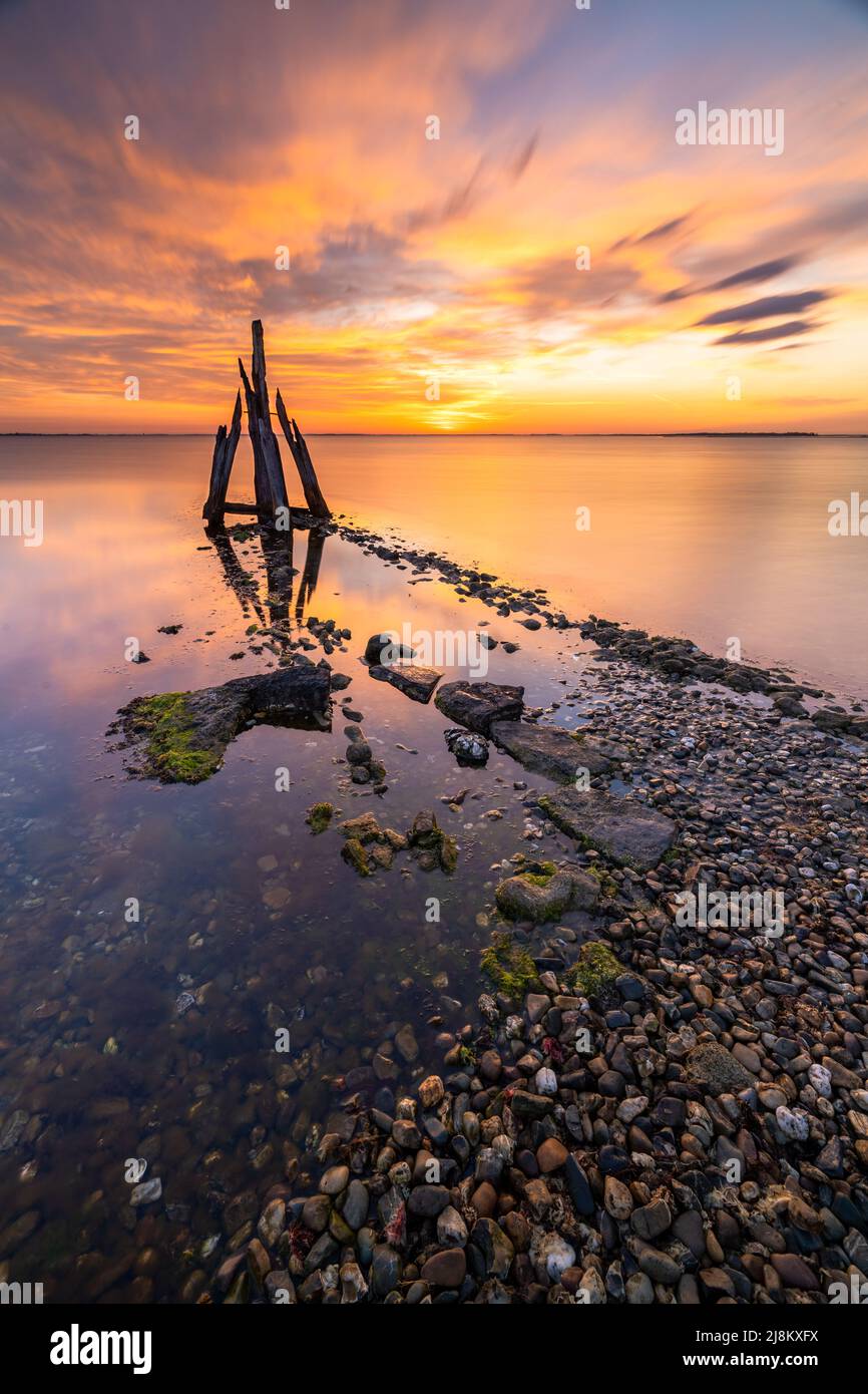 a piece of art standing at the coastline of the netherlands Stock Photo