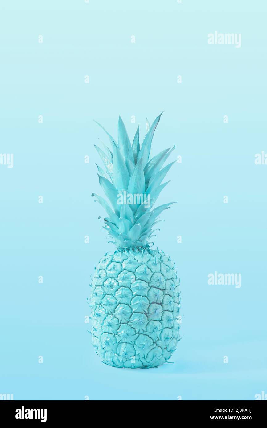 Creative blue Summer tropical fruit concept of pastel tasty pineapple. A refreshing healthy snack. Stock Photo
