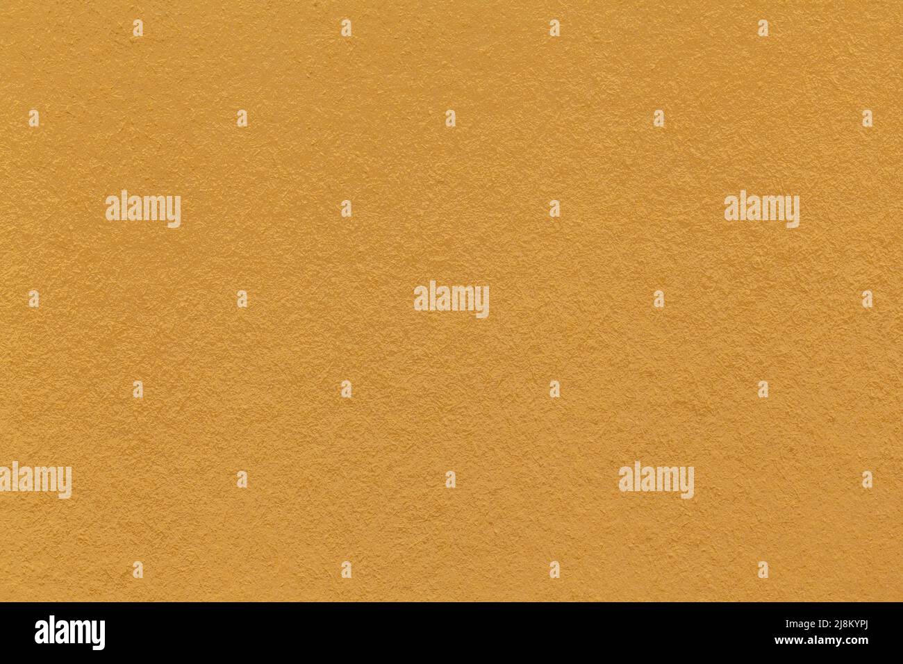 Texture of dark yellow and orange colors paper background, macro. Structure of dense ocher craft cardboard. Felt backdrop closeup. Stock Photo