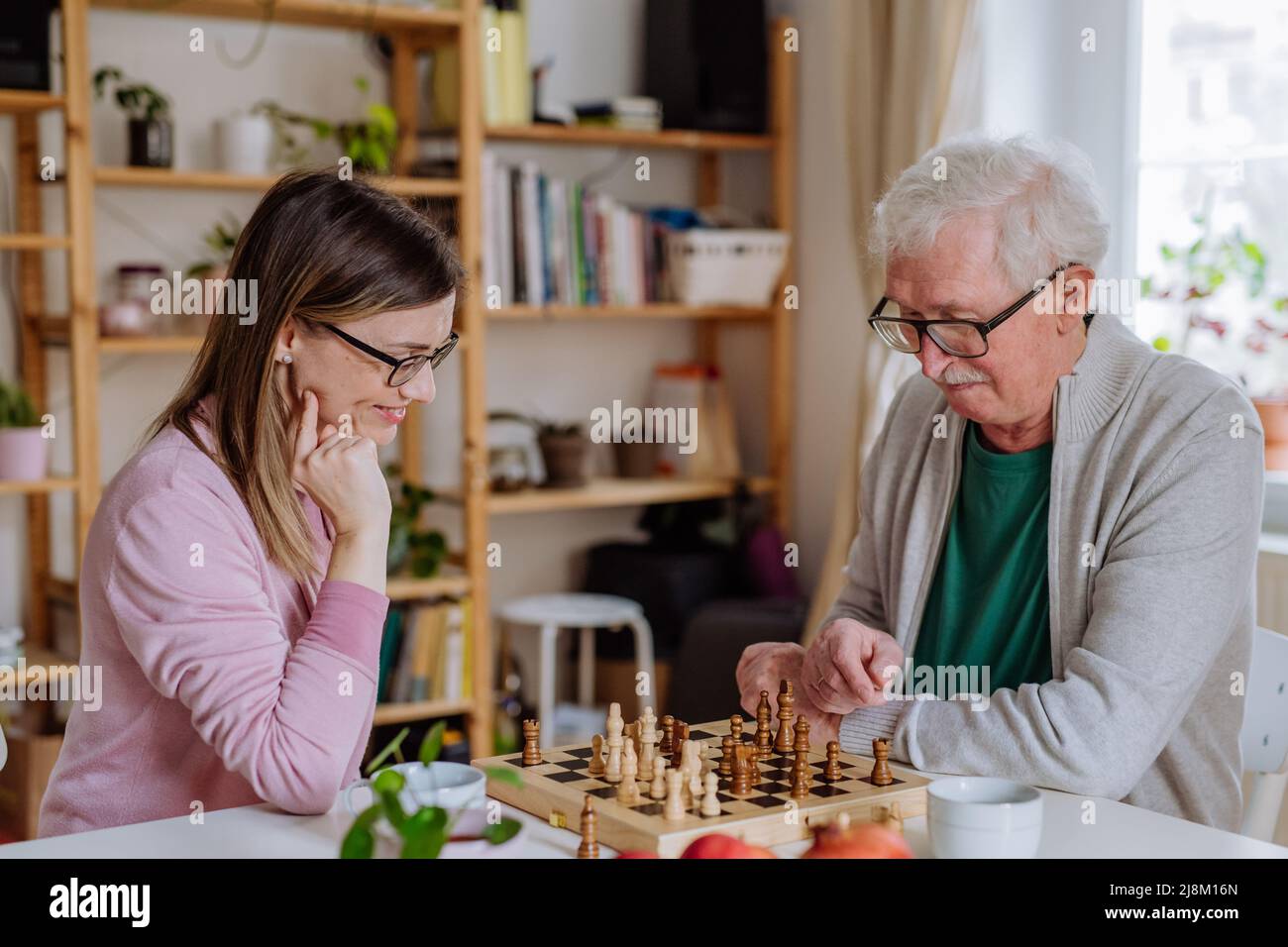 Daughter Picking Best Chess Moves For Parents While Playing Chess In  Mountain Cottage Stock Photo - Download Image Now - iStock