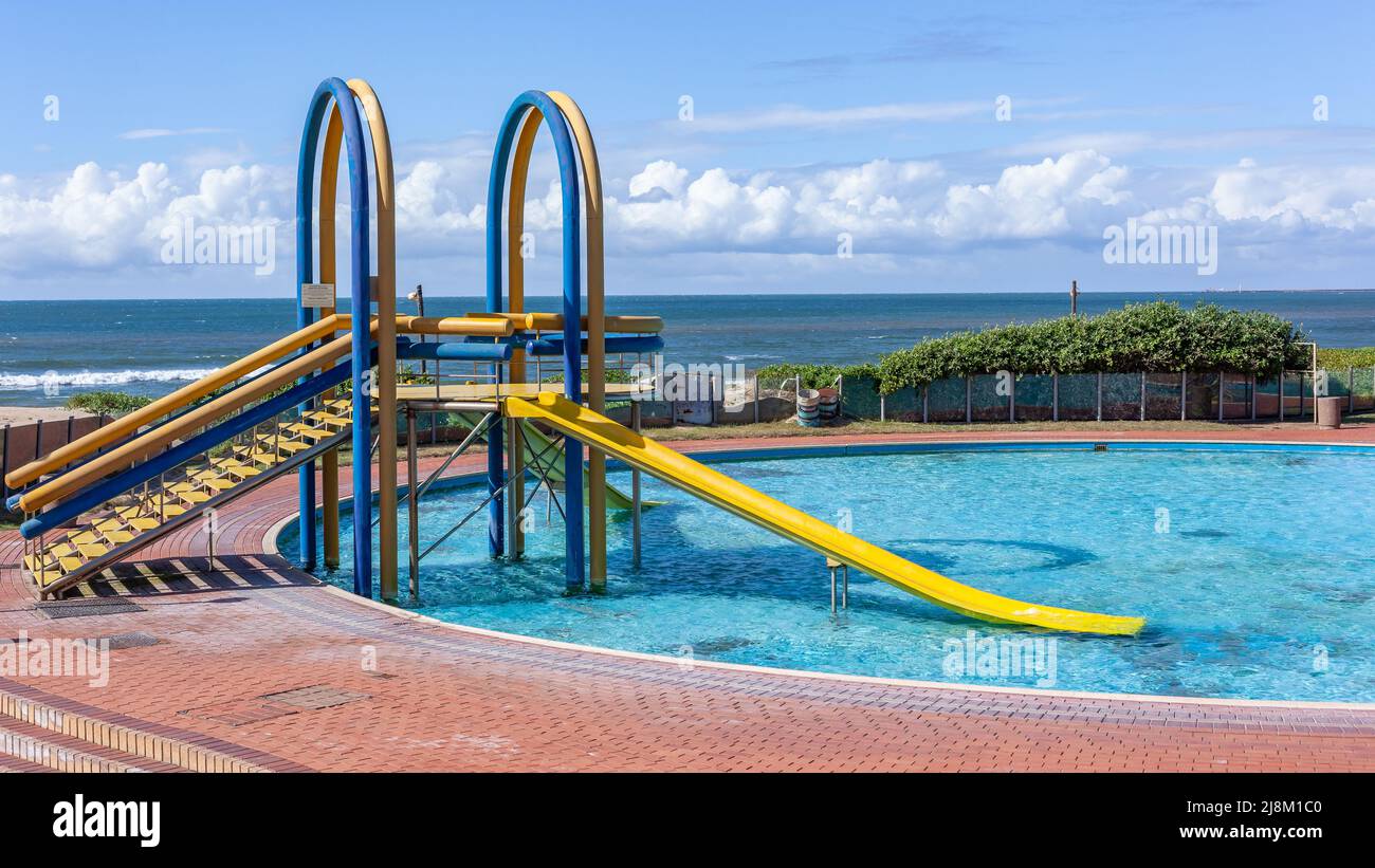 Swimming pools water slides a public holiday facility along Durban beach front landscape Stock
