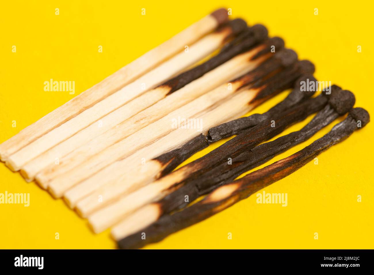 Different stages of match burning. Burnt matches on yellow background