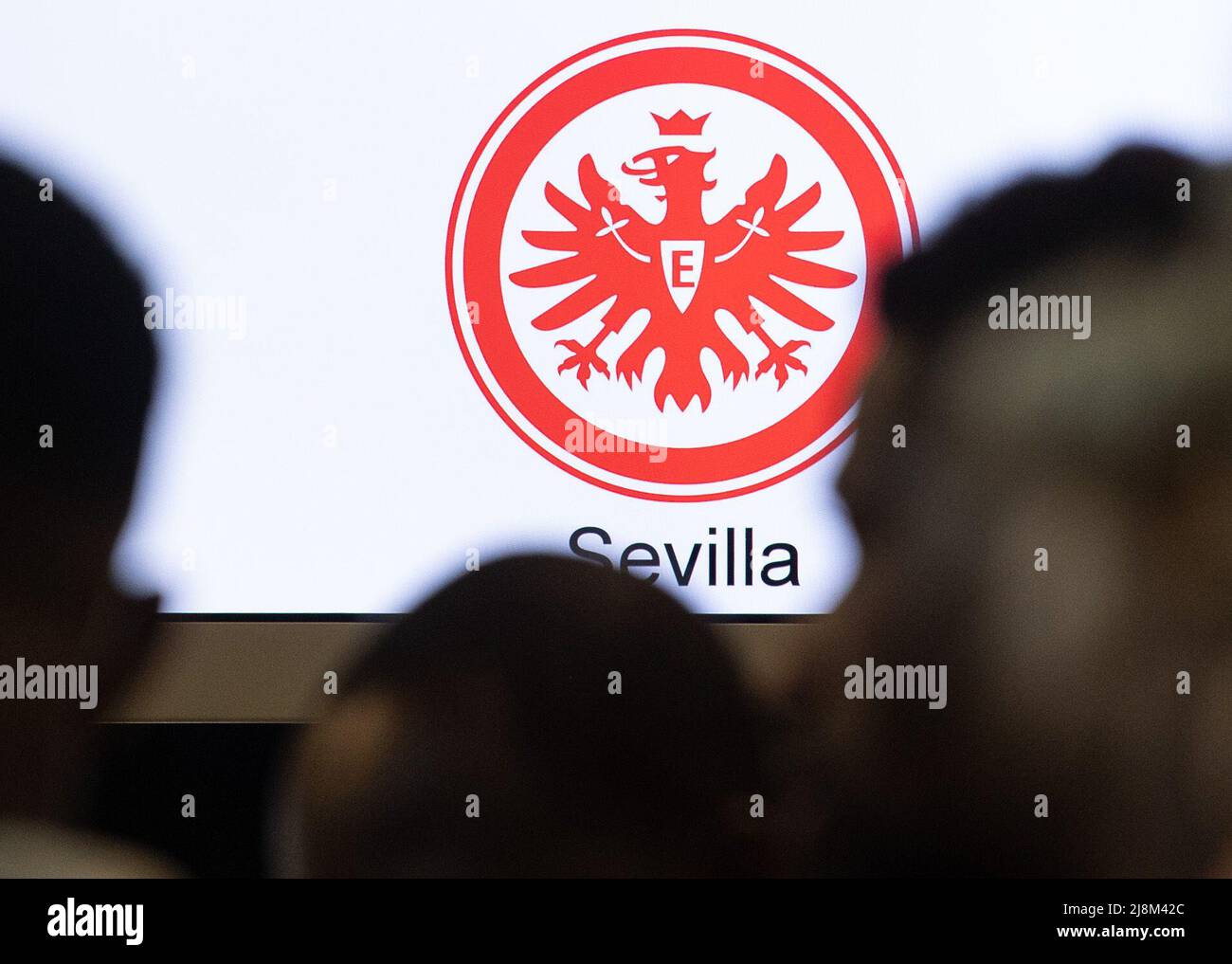 17 May 2022, Hessen, Frankfurt/Main: The crest of Eintracht Frankfurt is seen at the counter of an airline at Frankfurt Airport as passengers check in here for a flight to Seville. There, Eintracht Frankfurt will face Glasgow Rangers in the Europa League on Wednesday (18.05). Photo: Boris Roessler/dpa Stock Photo