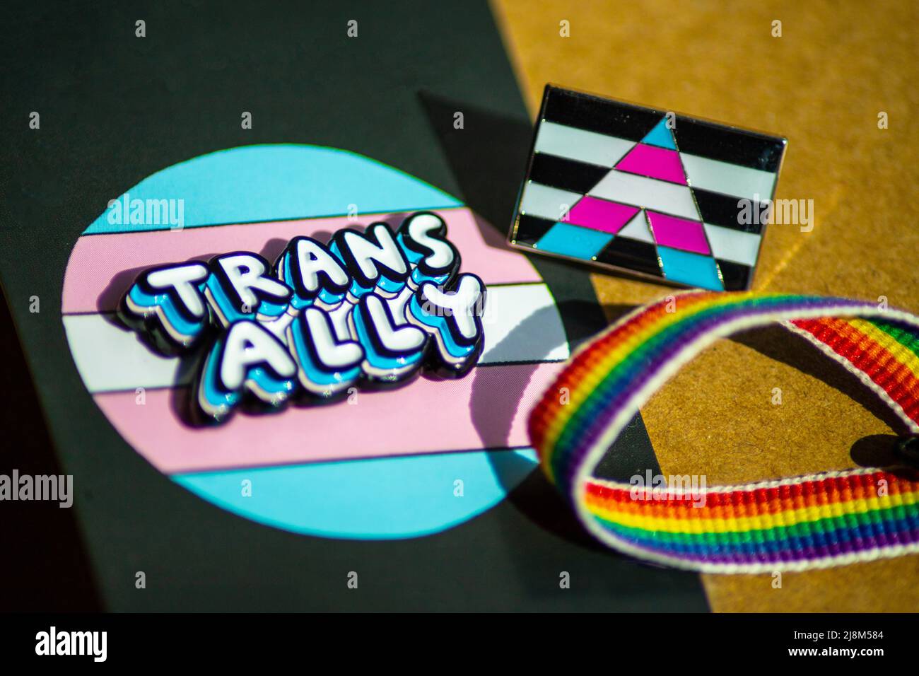 Close up of 'trans ally' and trans ally flag badge with a rainbow ribbon Stock Photo