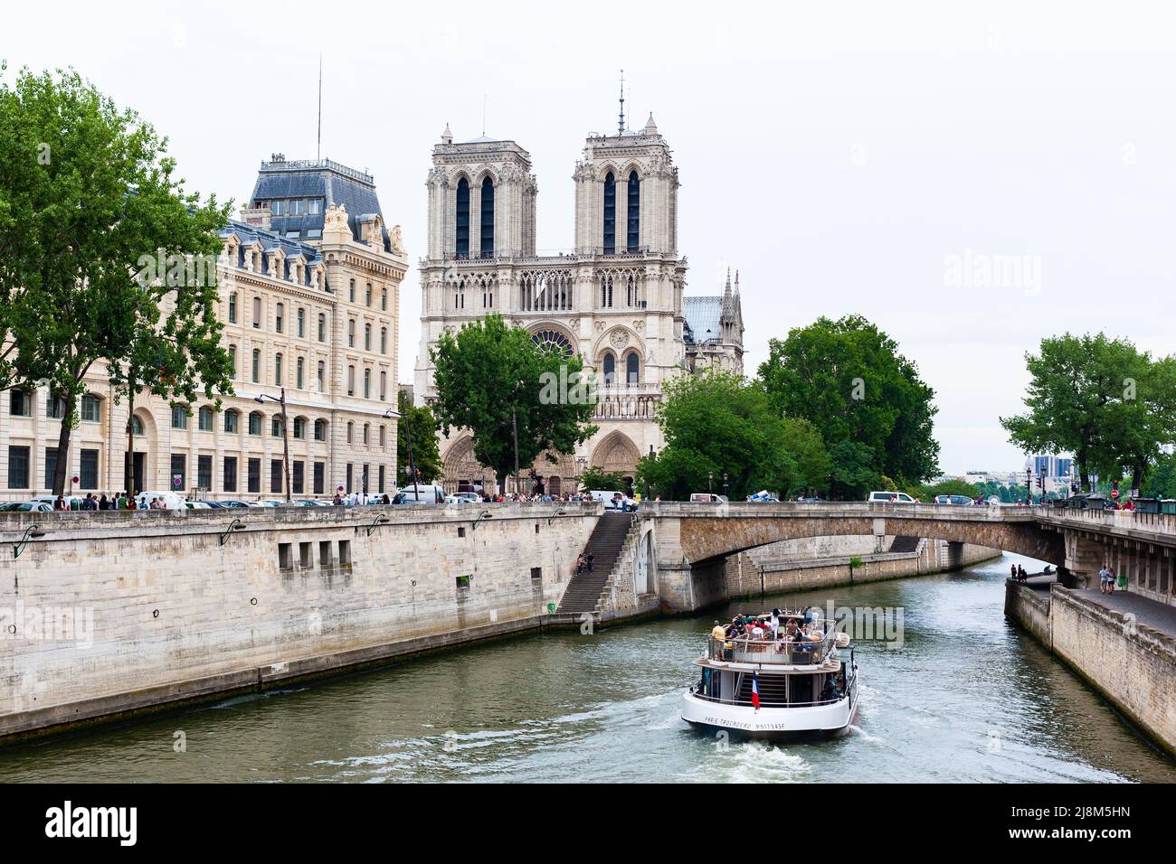 Paris, France - July 21, 2010 : Tour boat on Seine River approaching Notre-Dame Cathedral. Stock Photo