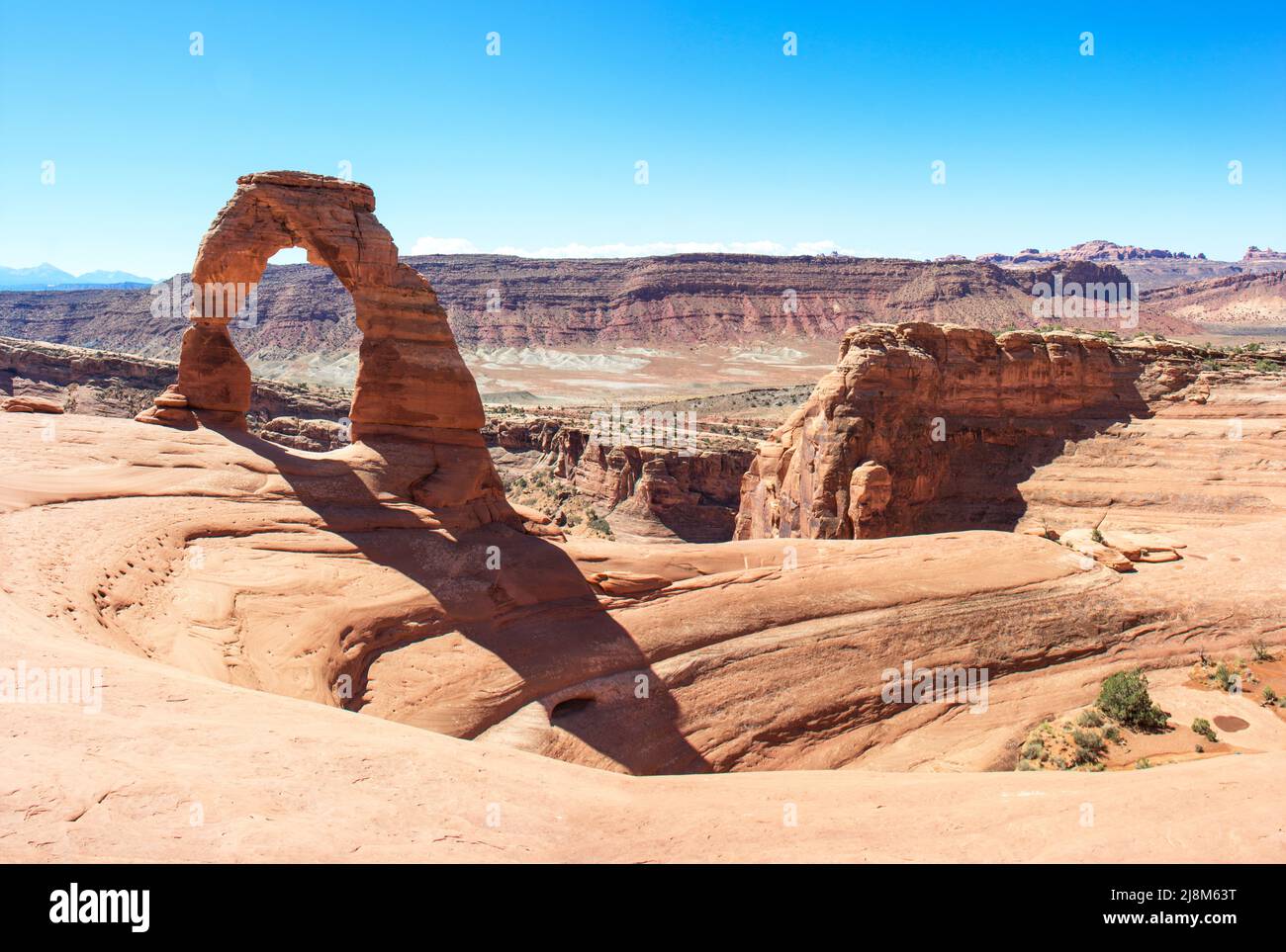 Delicate Arch in Arches National Park Utah America. Remarkable Landmark. Natural stone Arch in front of Blue Sky. High Resolution in Poster format. Stock Photo