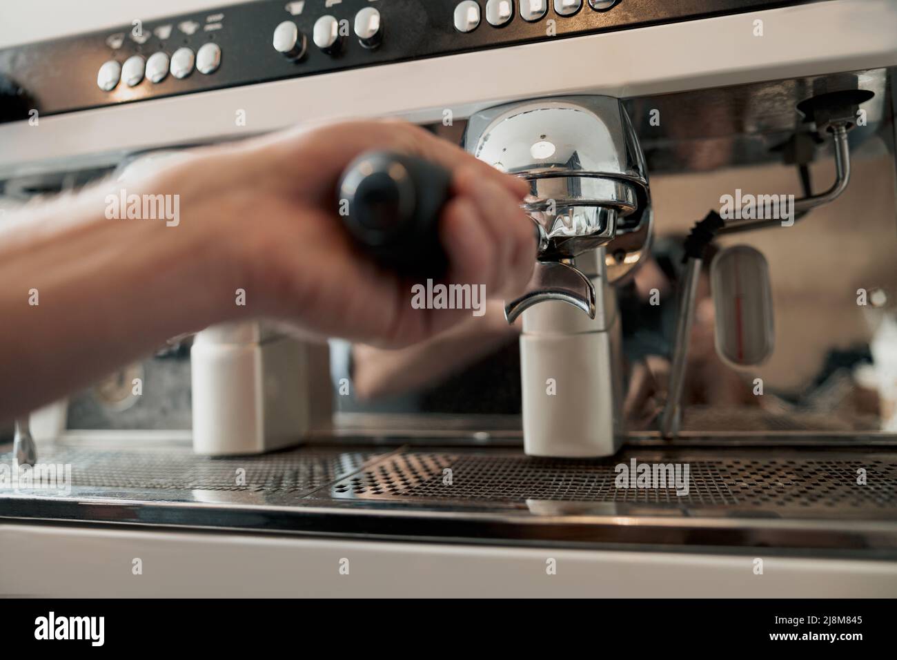 Photo of the process of installing portafilter in coffee machine Stock