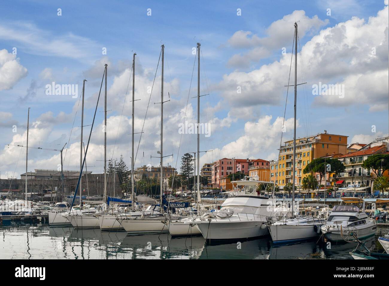 Sailboats moored in the Old Port with the waterfront and cityscape in the  background, Sanremo, Imperia, Liguria, Italy Stock Photo - Alamy