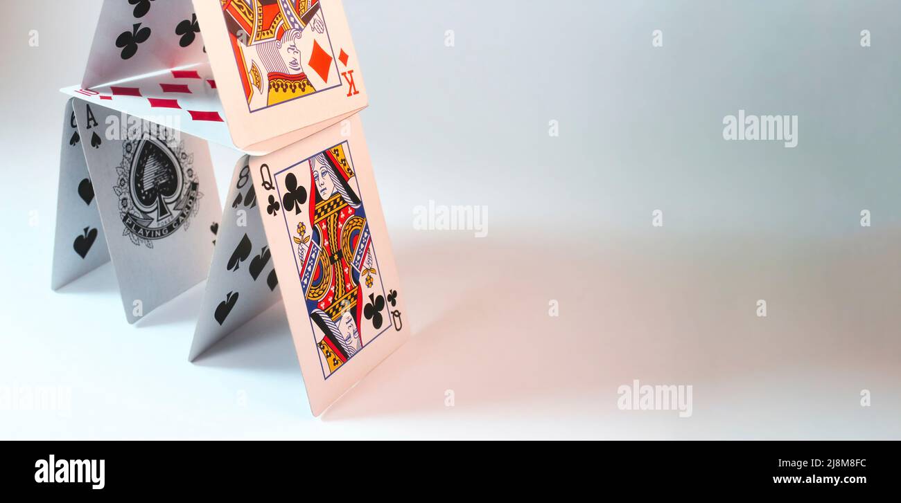 House of stacked playing cards against a white background with room for text placement Stock Photo