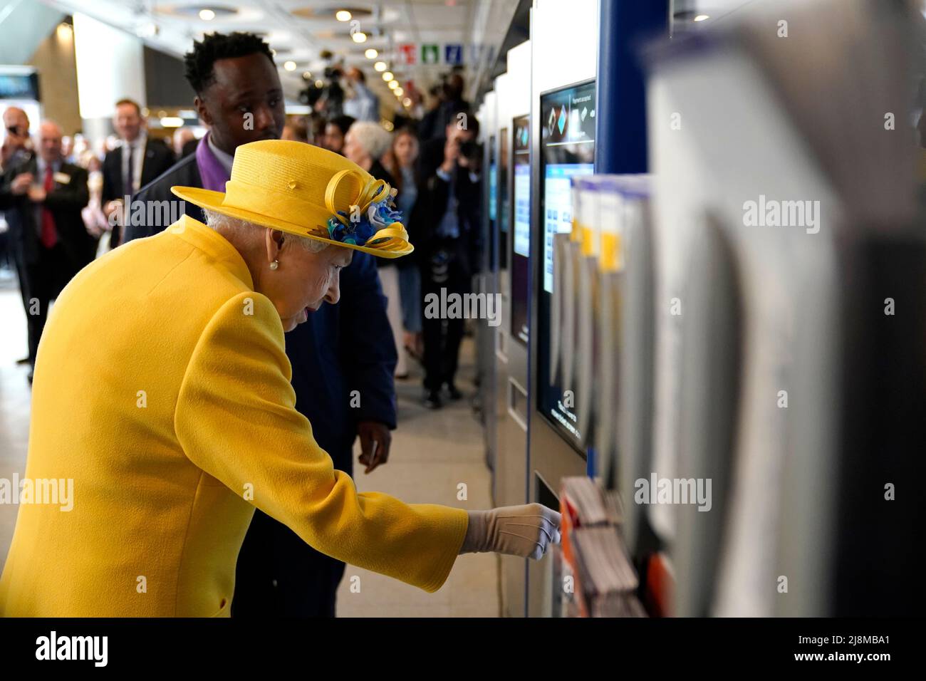 Queen Elizabeth II using a oyster card machine at Paddington station in