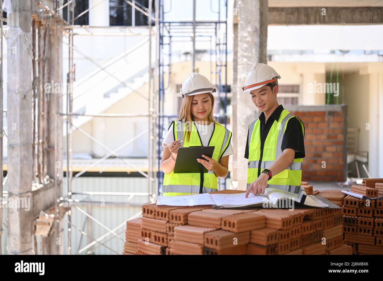 Female inspectors discussing with engineer about construction project