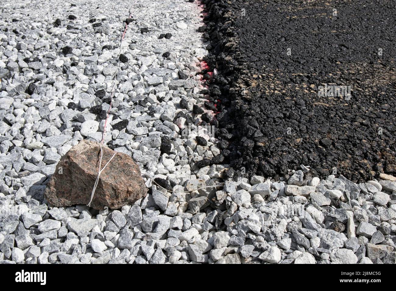 layer of fresh black asphalt on grey gravel Stock Photo Alamy