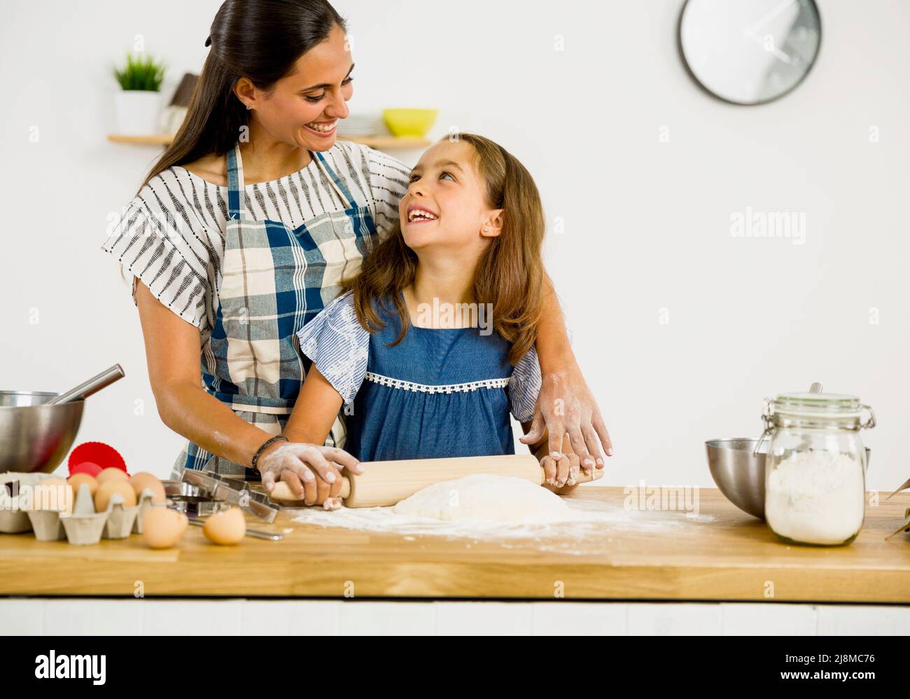 Shot of a mother and daughter having fun in the kitchen and learning to make a cake Stock Photo