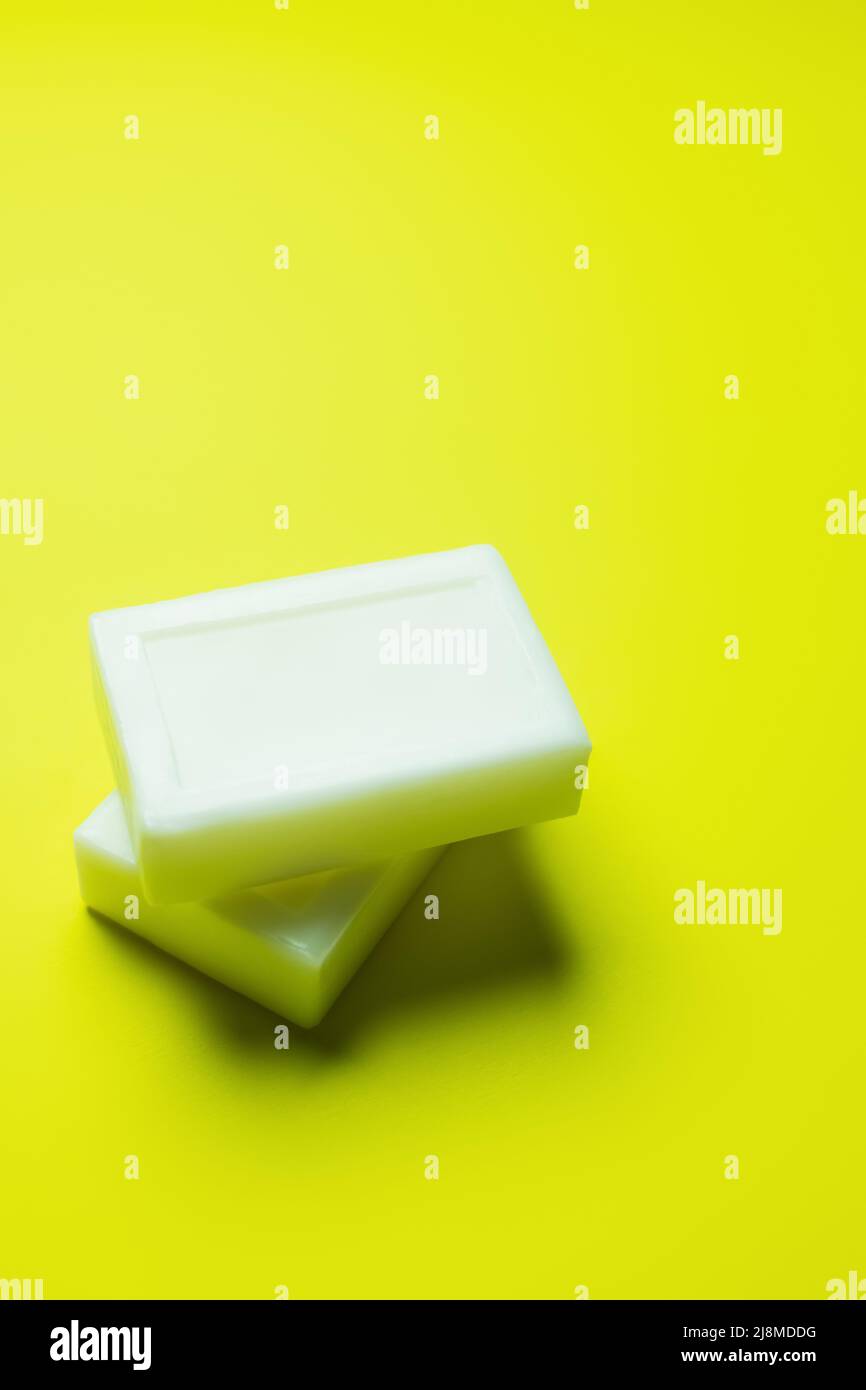 white soap bars on bright yellow background Stock Photo Alamy