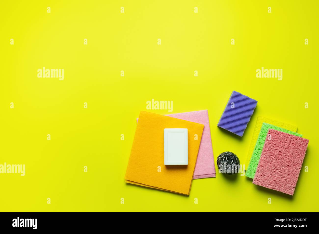 top view of multicolored dishrags, scouring pad, sponge cloths, metal