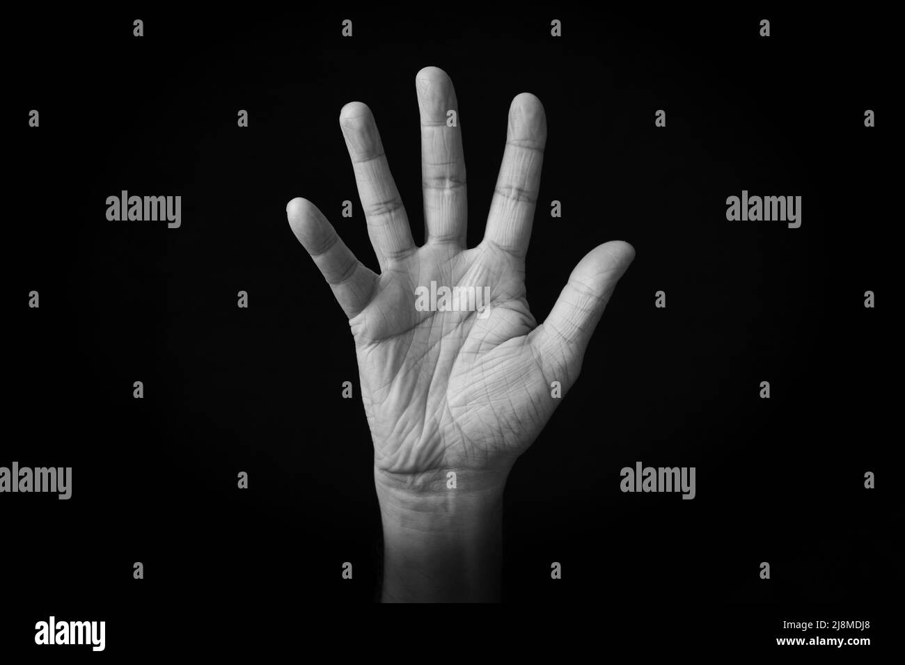 Dramatic black and white image of Hand with Fingers Splayed emoji isolated on black background